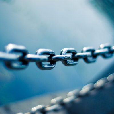 a metal chain in front of a blue background